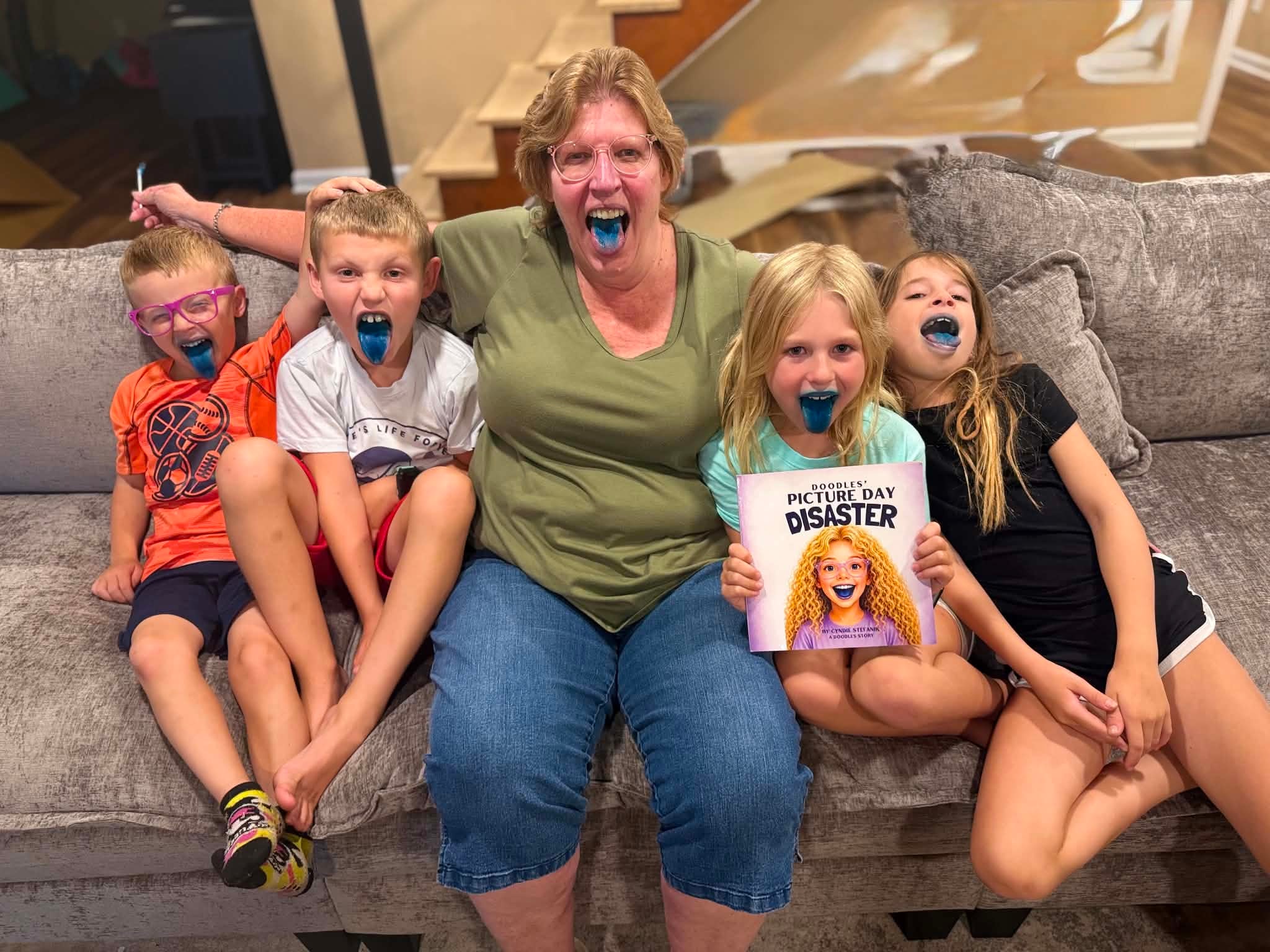 Grandma and grandchildren showing off their blue smiles together